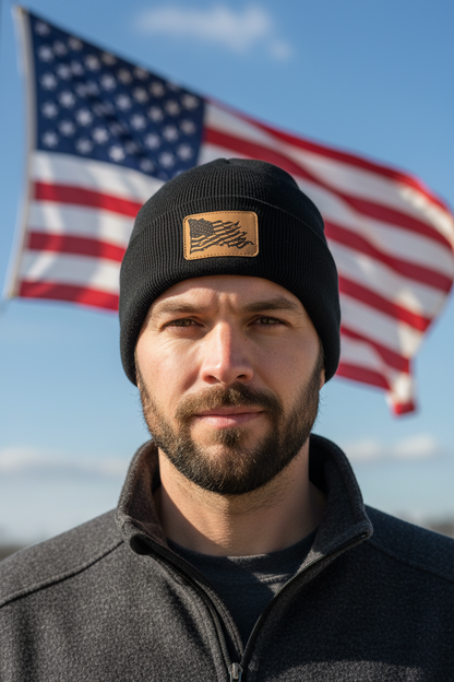 Black knit beanie with tan patch featuring wavy American flag design